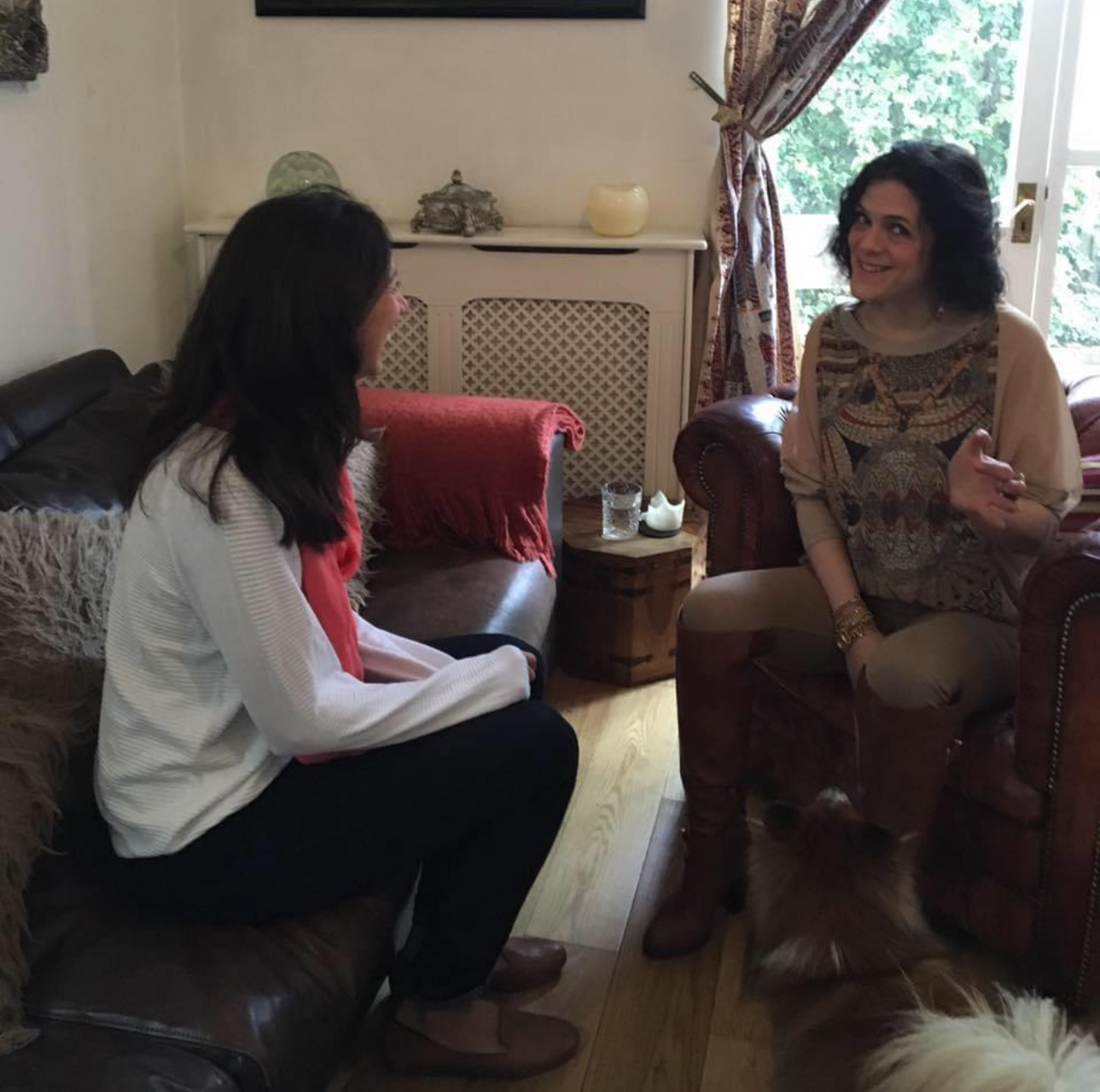 Photograph of Poppy talking with a client